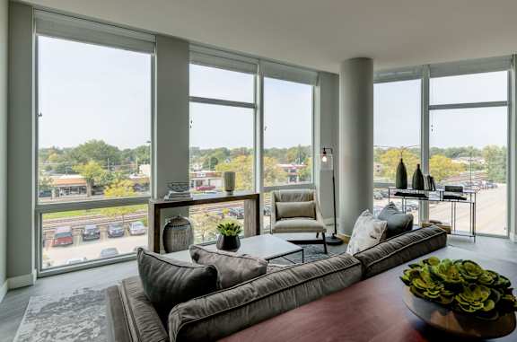 a living room filled with furniture and a large window
