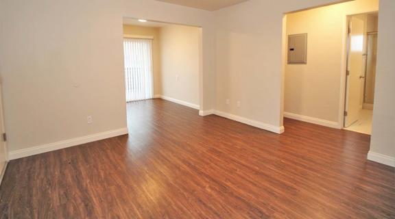 a picture of a room with white walls and a cat in the corner