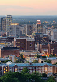 A cityscape with buildings and trees in the foreground.
