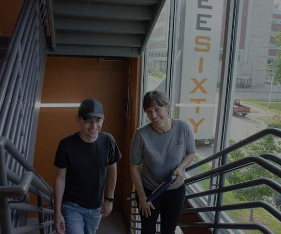 two young men walking down the stairs outside of a building