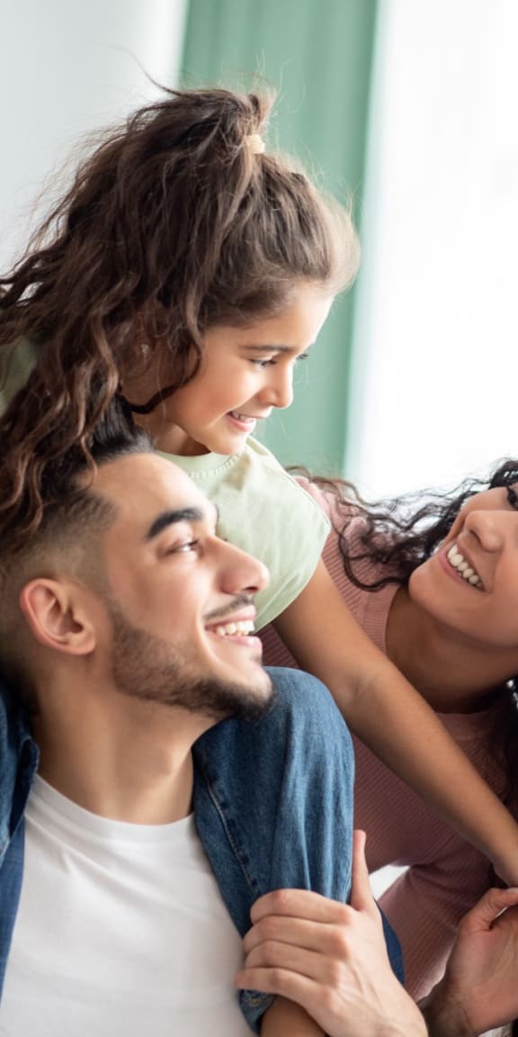 Cheerful Young Family Playing Together