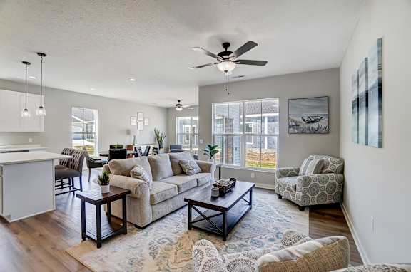 A living room with a couch, chairs, and a coffee table.