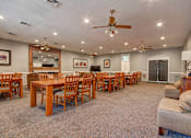 Thumbnail 12 of 26 - A large room with a dining table and chairs.