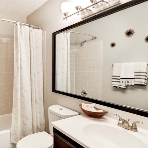 a bathroom with a shower toilet and sink and a mirror at Hamilton at Kings Place, Columbia, MD 21046