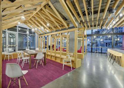 a dining room with tables and chairs and a building in the background at L Seven, CA 94103