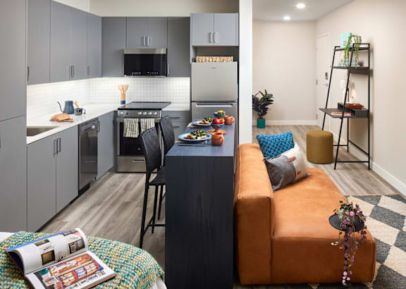 a living room and kitchen with a couch and a table