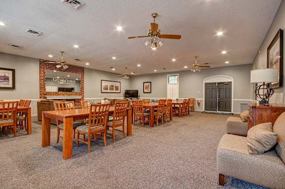 A large room with a dining table and chairs.