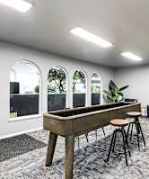 A room with a pool table and a chair.