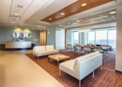Thumbnail 10 of 18 - A modern office space with white furniture and wood flooring.