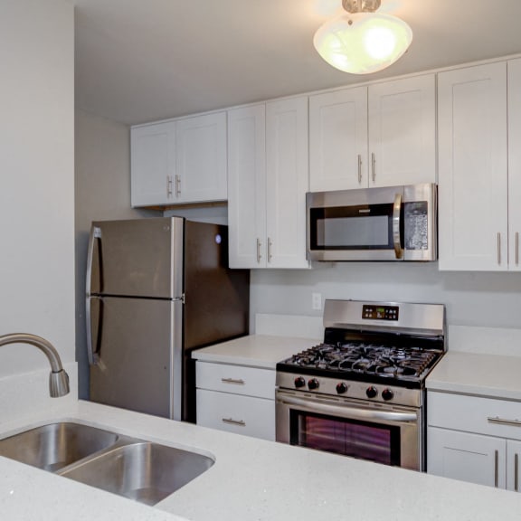an empty kitchen with a stove and a sink