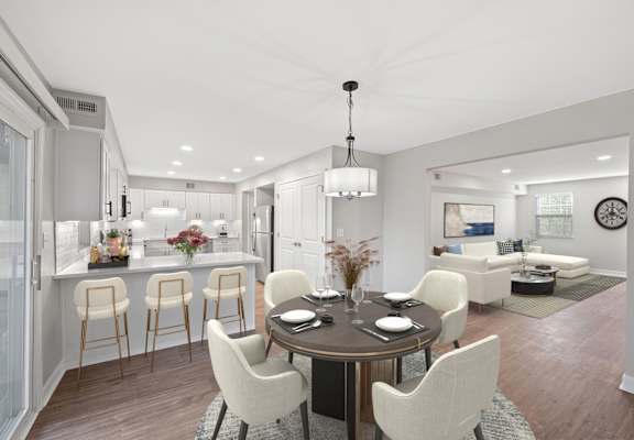 A modern dining room with a round table and chairs.