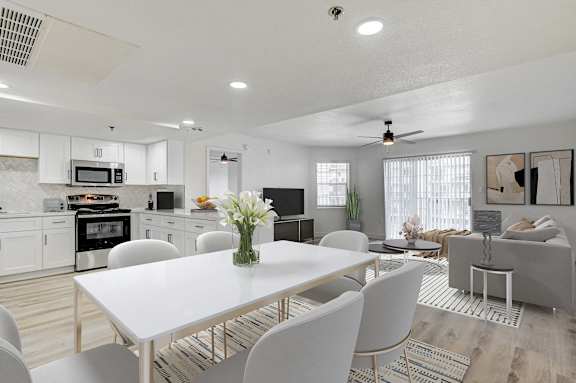 A modern kitchen with a dining table and chairs.