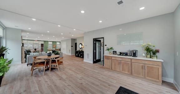 a living room and dining room with a table and chairs