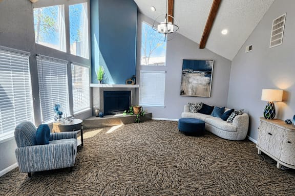 Clubhouse living room at Skyler Ridge with grey carpeting, sofa seating, and coffee tables.