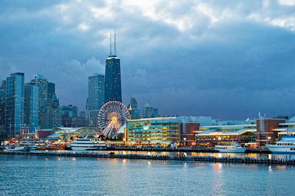 a ferris wheel in front of the seattle skyline