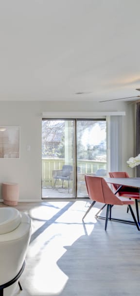 a living room with a gray couch and two white chairs