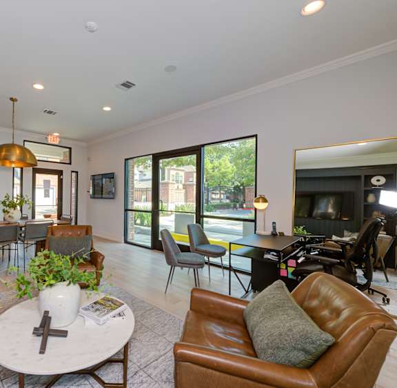 a living room with leather furniture and a table with chairs