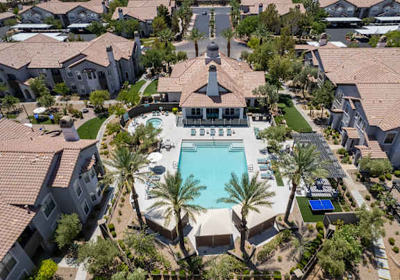 A large house with a pool in the middle of a neighborhood.