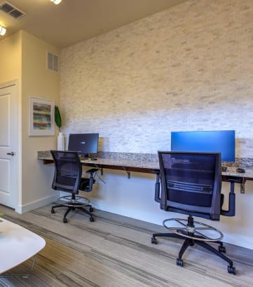 two computers on a desk in an office