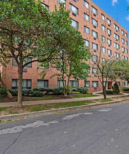 an empty street in front of a tall brick building
