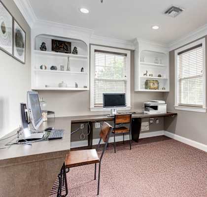 A home office with a desk, chair, and computer.