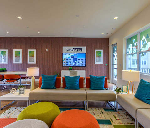 a living room filled with furniture and a flat screen tv at Lake Lofts at Deerwood, Florida, 32216