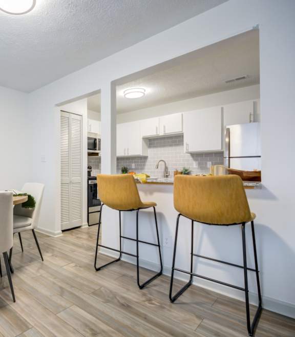 Dining room and kitchen with a table and chairs at The Waters at Chenal Apartments, Arkansas, 72211