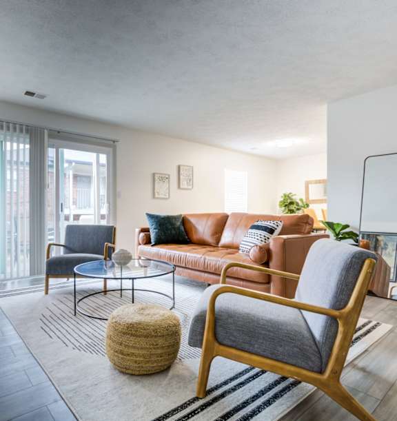 Living Room with Brown couch and chair at The Waters at Chenal Apartments, Little Rock, Arkansas