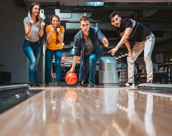 Group of Friends Bowling Together Having Fun