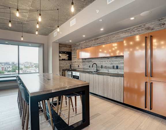 A modern kitchen with a wooden table and chairs.