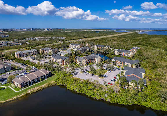 A bird's eye view of a residential area with houses and a body of water.