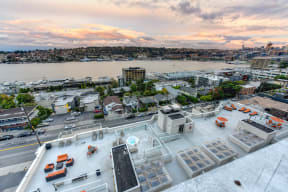 Community Rooftop Lounge Area with View of City, Pink Clouds and Street