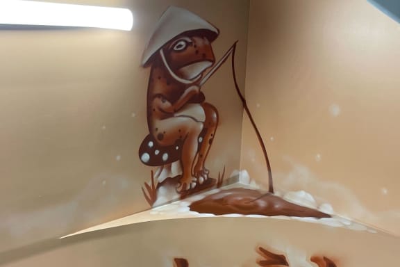 mural of a frog wearing a hat and fising in a pond at The Citizen Birmingham