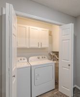 A small laundry room with a washer and dryer.