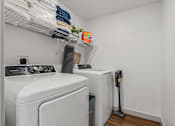 Thumbnail 18 of 20 - Washer and dryer in a small laundry room with white walls at City View St. George, St. George, Utah