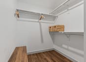 Thumbnail 19 of 20 - Walk in closet with white walls and wooden floor at City View St. George, Utah, 84770
