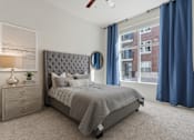 Thumbnail 16 of 21 - Bedroom with a grey bed and a grey dresser with a plant on top at 200 City View, Provo, UT