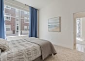 Thumbnail 17 of 21 - Bedroom with a large bed and a painting on the wall at 200 City View, Provo