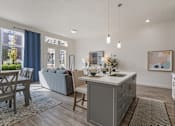 Thumbnail 4 of 21 - Modern kitchen with a grey island and wooden floors at 200 City View, Utah