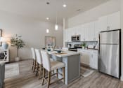 Thumbnail 6 of 21 - Modern kitchen with a dining table and chairs at 200 City View, Provo, UT, 84601