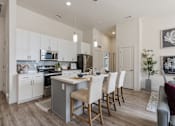 Thumbnail 7 of 21 - Modern kitchen with a dining table and chairs at 200 City View, Provo, UT