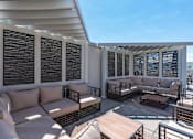 Thumbnail 41 of 42 - a patio with couches and tables on a roof 605 Place Student Housing & Co-Living, St George, UT 84770