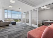 Thumbnail 38 of 42 - A room with a grey carpet and a large window overlooking the mountains. 605 Place Student Housing & Co-Living, St George Utah