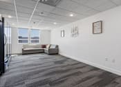 Thumbnail 35 of 42 - A room with a grey carpet and a white wall with two pictures on it. 605 Place Student Housing & Co-Living, St George, UT