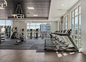 Thumbnail 28 of 42 - the gym with treadmills and windows at the district flats apartments 605 Place Student Housing & Co-Living, St George, UT 84770