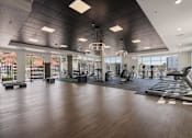 Thumbnail 37 of 42 - A spacious gym with a variety of equipment and a large mirror on the wall. 605 Place Student Housing & Co-Living, St George, 84770