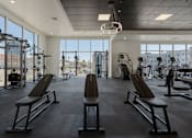 Thumbnail 15 of 42 - a gym with chest exercise equipment and large windows 605 Place Student Housing & Co-Living, St George, UT 84770