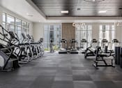 Thumbnail 24 of 42 - A gym with treadmills, elliptical machines and other cardio equipment. 605 Place Student Housing & Co-Living, St George