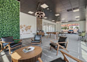 Thumbnail 19 of 42 - large lobby with black chairs and tables and a green wall 605 Place Student Housing & Co-Living, St George Utah
