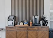 Thumbnail 23 of 42 - A coffee machine sits on a wooden cabinet with a digital display. 605 Place Student Housing & Co-Living, Utah
